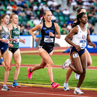Female BYU runner competing in a track meet