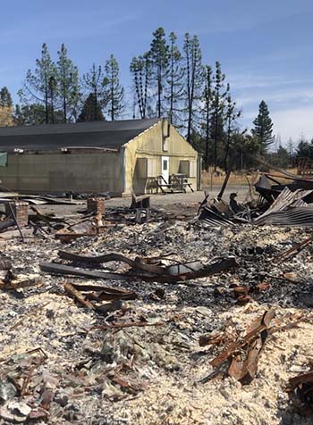 Building surrounded by rubble left from a fire.