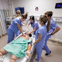 Group of BYU nursing students in scrubs in nursing class