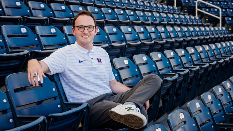 Young man sitting in stadium bleachers