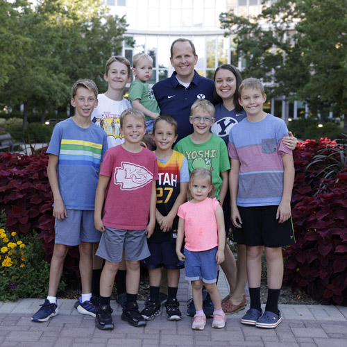A family posing for a photo while visiting BYU campus for PLC meetings