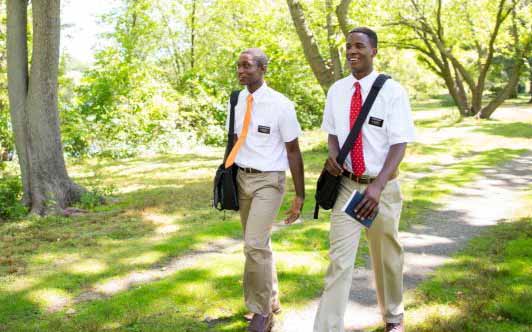 Missionaries walk together to their next appointment.