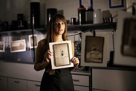 Picture of Erica Rascon holding one of her photos of a ballerina