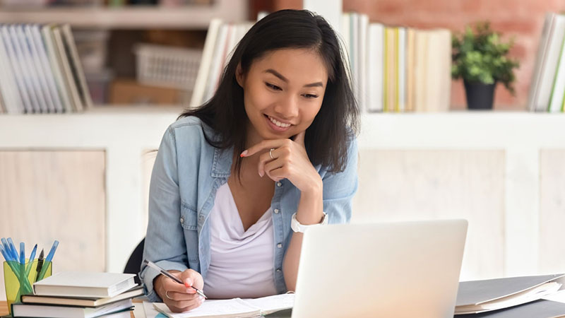 Female BYU-Pathway student studying on laptop