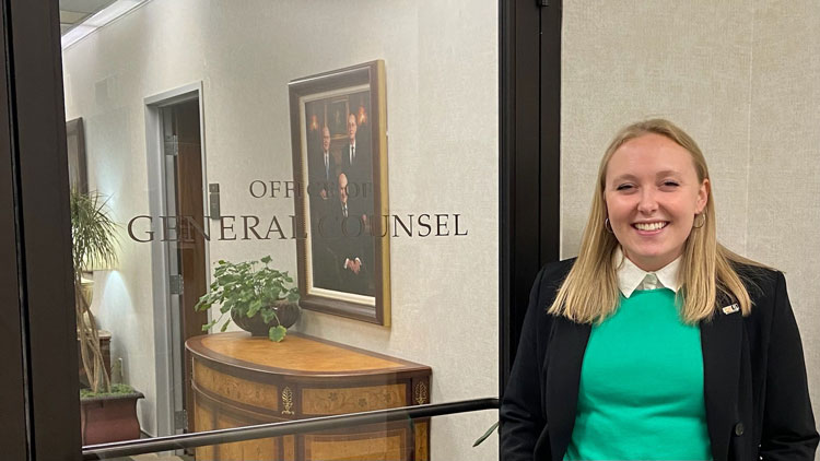 Sarah Johns standing outside the Office of General Counsel