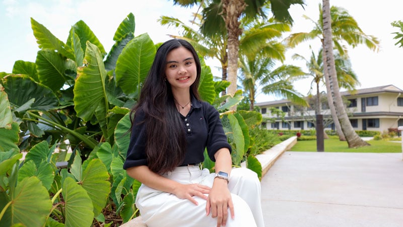 A female BYU-Hawaii student sitting outside