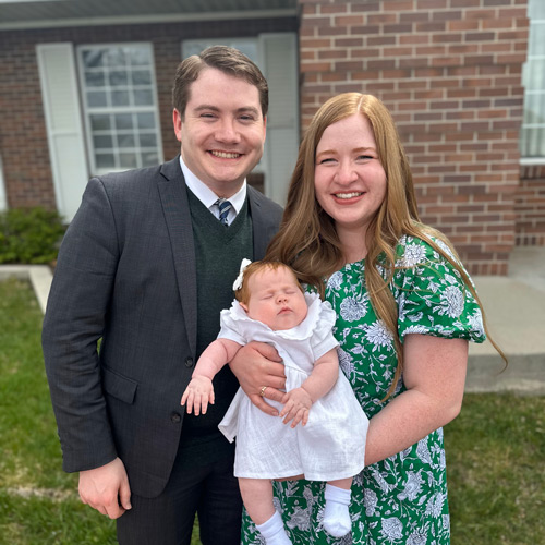 William Emery with his wife and baby outside