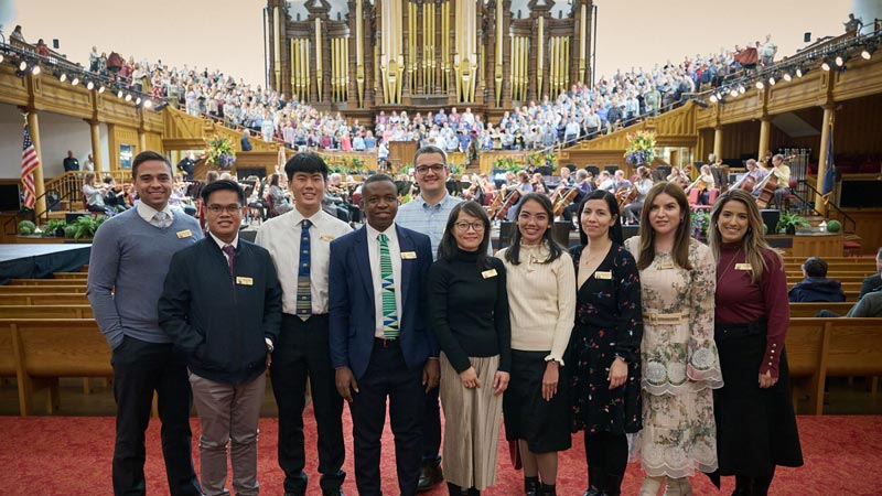 A group of international participants of the Tabernacle Choir pose together for a group photo