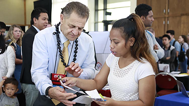 man helping student