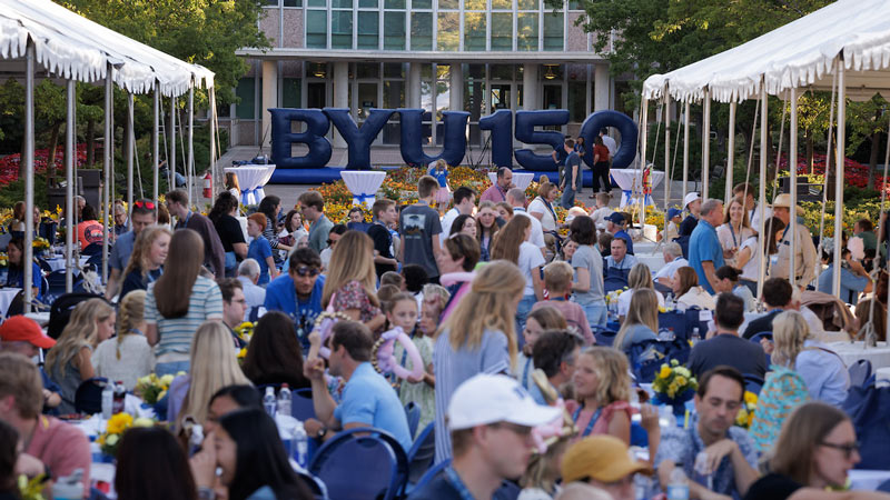 Large group of PLC attendees gathered outdoors for lunch on campus