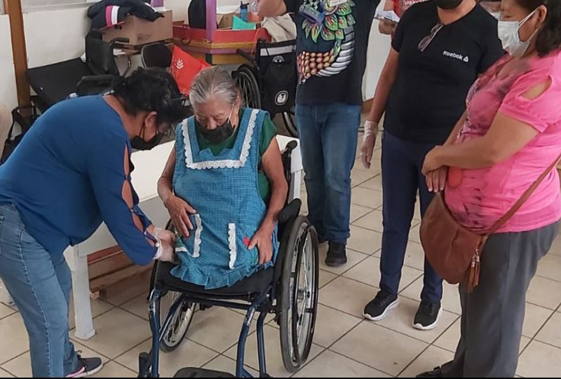 Mexican women sitting in a wheelchair