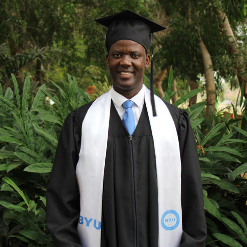 An African man wearing a graduation robe.