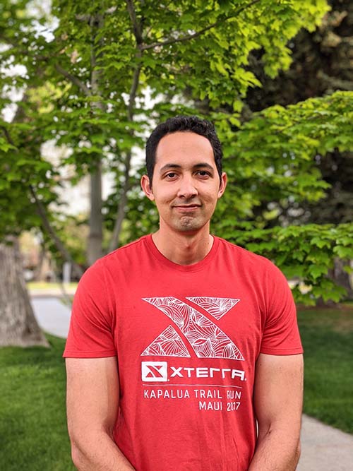 McKay School of Education student Nathan Kahaiali‘i standing in front of a tree 