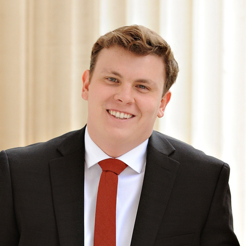 Male college student wearing suit jacket and tie.