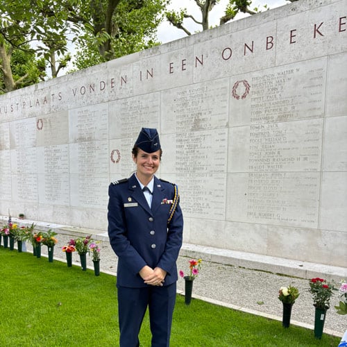 Anaiya Harris in her Air Force uniform standing in front of a memorial