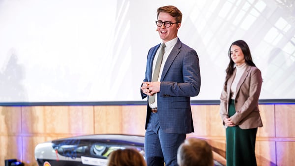 Jameston Millar in a suit making a business presentation