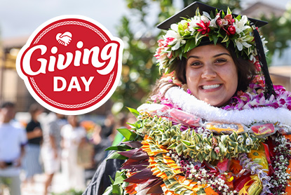 Smiling female BYU-Hawaii graduate in her cap and gown and leis, with the Giving Day logo to the left