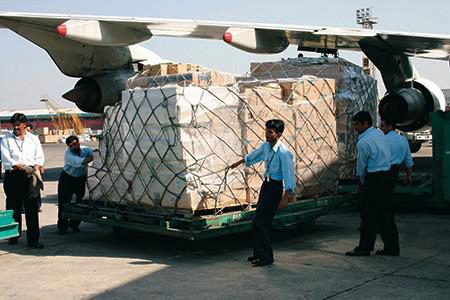 people helping move a large transport of medical supplies