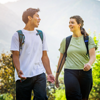 Two BYU students walking and talking on a sunny day on campus