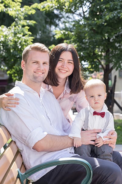 family sitting on bench outside
